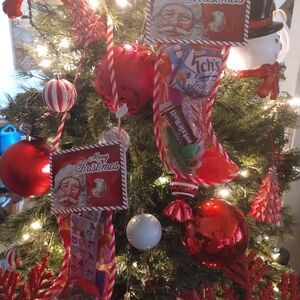 4 Christmas stockings filled with Christmas assortments